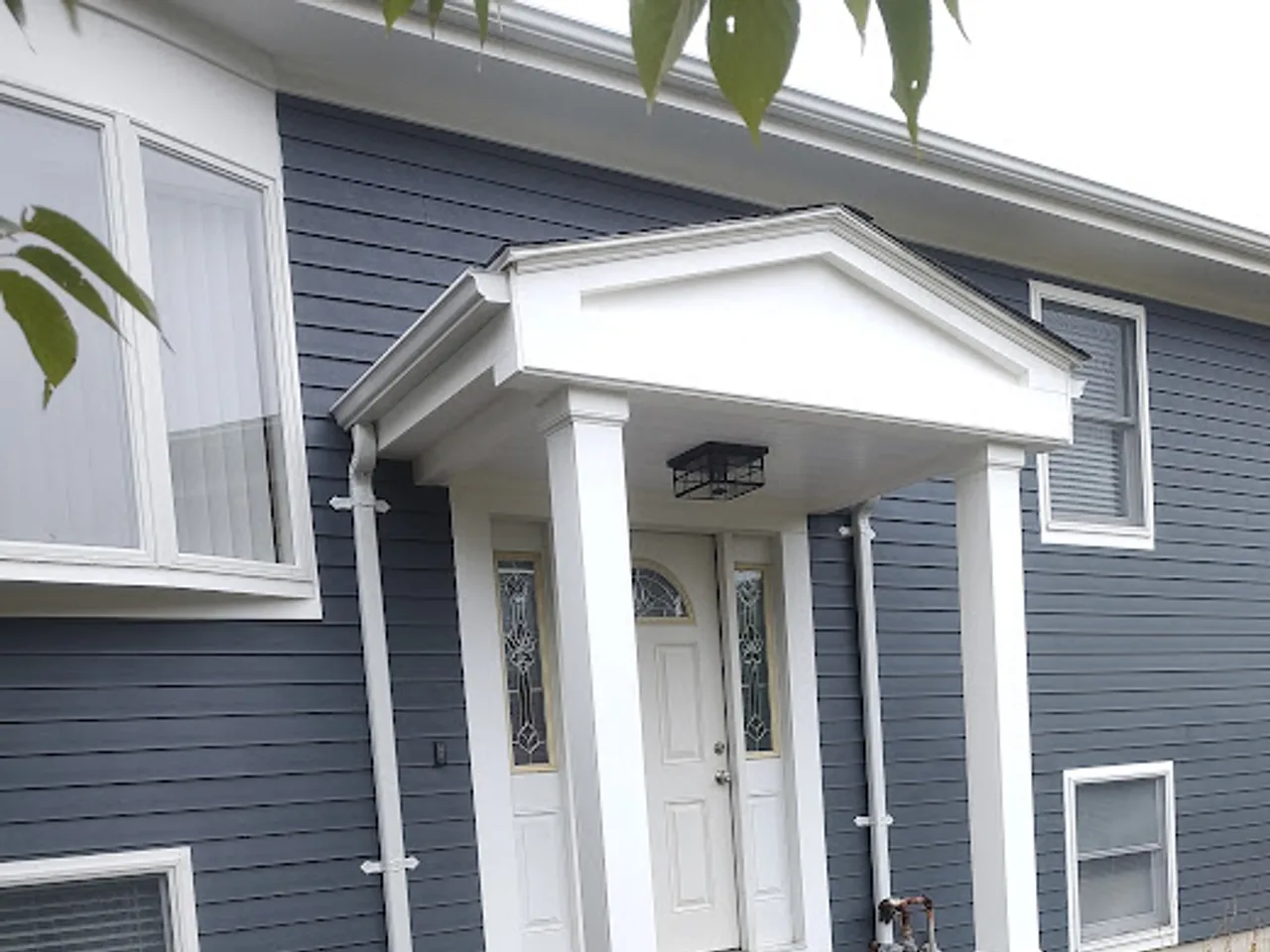 Siding, portico, and stone steps in Bridgewater, MA, after
